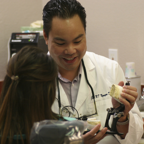 Dr. Joe Nguyen showing a patient how dental restorations work