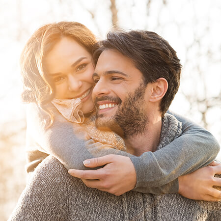 A couple with beautiful smiles laughing together